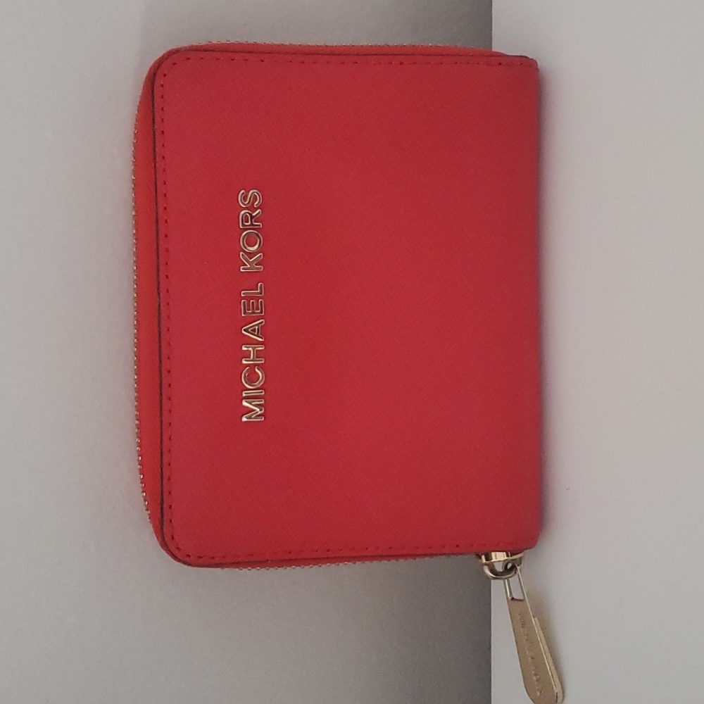 Micheal Kors Red Leather Wallet with Zipper closure.